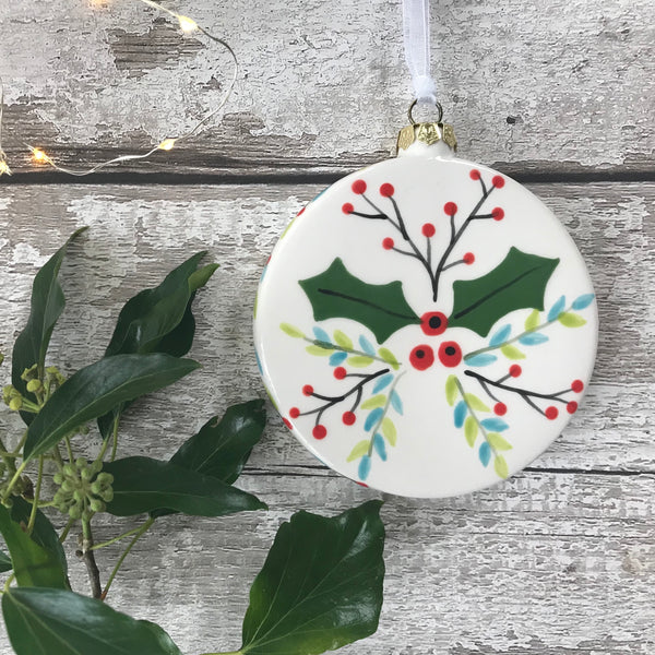 Hand painted ceramic flattened baunble Christmas Decoration - Holly & Berries design with hand painted edge
