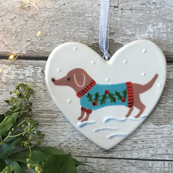 Hand Painted Ceramic Heart Christmas Decoration - Tan Sausage Dog/Dachshund wearing a festive jumper sitting in the snow